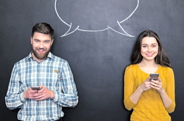 Man and woman holding phones with chalkboard speech bubble